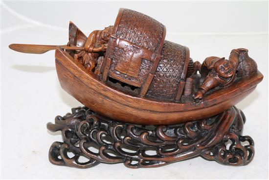 A Chinese bamboo model of a junk boat, with a stand carved as waves, late 19th/early 20th century, length 30cm